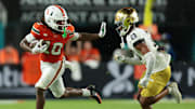 Aug 31, 2025; Miami Gardens, Florida, USA; Miami Hurricanes wide receiver Malachi Toney (10) runs with the football against Notre Dame Fighting Irish cornerback Karson Hobbs (21) during the first half at Hard Rock Stadium. Mandatory Credit: Sam Navarro-Imagn Images