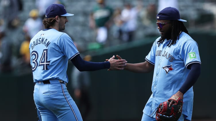 Toronto Blue Jays starting pitcher Kevin Gausman and first baseman Vladimir Guerrero Jr.