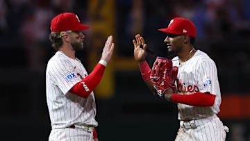 Apr 30, 2025; Philadelphia, Pennsylvania, USA; Philadelphia Phillies first base Bryce Harper (3) high fives outfielder Johan Rojas (23) after a victory against the Washington Nationals at Citizens Bank Park. 