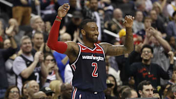 Dec 16, 2018; Washington, DC, USA; Washington Wizards guard John Wall (2) celebrates on the bench against the Los Angeles Lakers in the fourth quarter at Capital One Arena.  The Wizards won 128-110. Mandatory Credit: Geoff Burke-Imagn Images