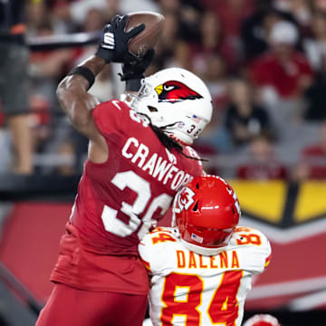 Aug 9, 2025; Glendale, Arizona, USA; Arizona Cardinals safety Kitan Crawford (36) intercepts a pass intended for Kansas City Chiefs wide receiver Mac Dalena (84) during a preseason NFL game at State Farm Stadium. Mandatory Credit: Mark J. Rebilas-Imagn Images