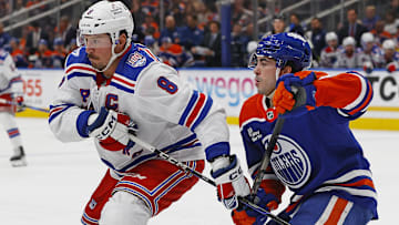 Oct 30, 2025; Edmonton, Alberta, CAN; New York Rangers forward J.T. Miller (8) and Edmonton Oilers forward Matt Savoie (22) battles for position during the second period at Rogers Place. Mandatory Credit: Perry Nelson-Imagn Images