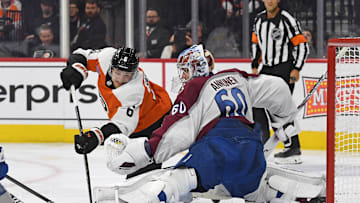 Nov 18, 2024; Philadelphia, Pennsylvania, USA; Colorado Avalanche goaltender Justus Annunen (60) makes a save against Philadelphia Flyers defenseman Travis Sanheim (6) during the third period at Wells Fargo Center. Mandatory Credit: Eric Hartline-Imagn Images