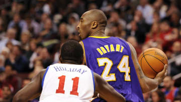 Feb 06, 2012; Philadelphia, PA, USA; Los Angeles Lakers guard Kobe Bryant (24) is defended by Philadelphia 76ers guard Jrue Holiday (11) during the second quarter at the Wells Fargo Center. The Sixers defeated the Lakers 95-90. Mandatory Credit: Howard Smith-USA TODAY Sports