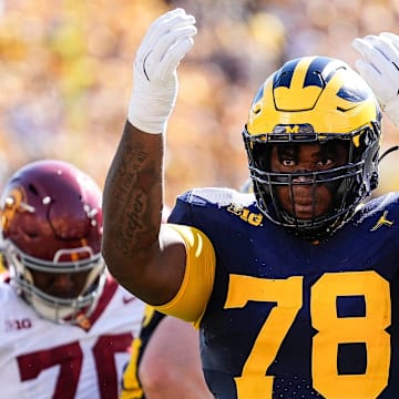 Michigan defensive lineman Kenneth Grant (78) celebrates a tackle against USC during the first half at Michigan Stadium in Ann Arbor .