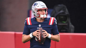 August 8, 2024; Foxborough, MA, USA;  New England Patriots quarterback Bailey Zappe (4) warms up before a game against the Carolina Panthers at Gillette Stadium. Mandatory Credit: Eric Canha-USA TODAY Sports