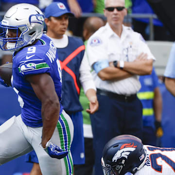 Sep 8, 2024; Seattle, Washington, USA; Seattle Seahawks running back Kenneth Walker III (9) breaks a tackle attempt by Denver Broncos cornerback Riley Moss (21) to rush for a touchdown during the third quarter at Lumen Field. Mandatory Credit: Joe Nicholson-Imagn Images