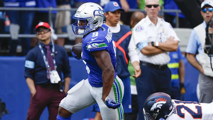 Sep 8, 2024; Seattle, Washington, USA; Seattle Seahawks running back Kenneth Walker III (9) breaks a tackle attempt by Denver Broncos cornerback Riley Moss (21) to rush for a touchdown during the third quarter at Lumen Field. Mandatory Credit: Joe Nicholson-Imagn Images