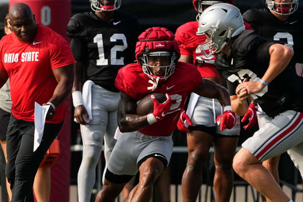Running back takes carry in practice.