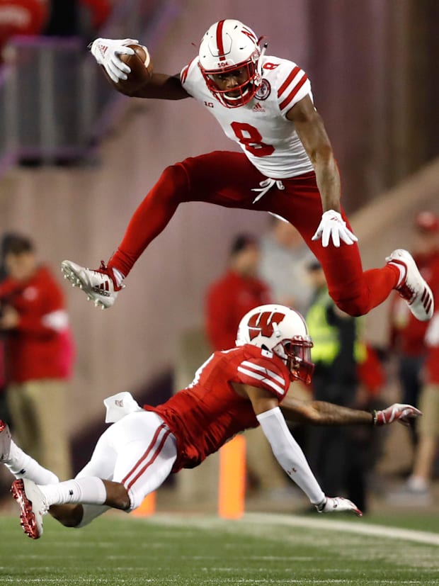Nebraska wide receiver Stanley Morgan Jr. leaps over Wisconsin cornerback Deron Harrell.