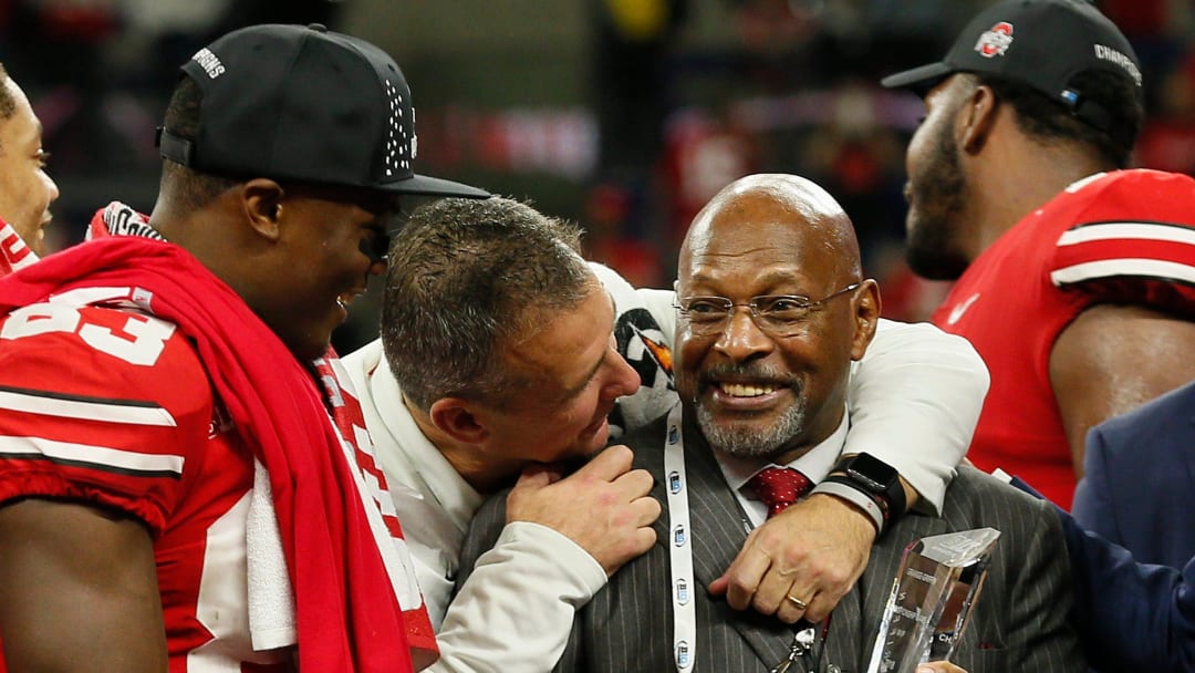 Ohio State Buckeyes head coach Urban Meyer hugs Archie Griffin as he prepares to hand the Grange-Griffin MVP trophy to quarterback Dwayne Haskins Jr. following their 45-24 win over the Northwestern Wildcats in the Big Ten Championship at Lucas Oil Stadium in Indianapolis on Dec. 1, 2018. [Adam Cairns/Dispatch]