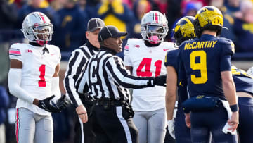 Nov 25, 2023; Ann Arbor, Michigan, USA; An official separates Ohio State Buckeyes cornerback Davison Igbinosun (1) and safety Josh Proctor (41) from Michigan Wolverines wide receiver Roman Wilson (1) and quarterback J.J. McCarthy (9) during the NCAA football game at Michigan Stadium. Ohio State lost 30-24.