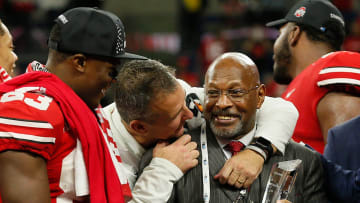 Ohio State Buckeyes head coach Urban Meyer hugs Archie Griffin as he prepares to hand the Grange-Griffin MVP trophy to quarterback Dwayne Haskins Jr. following their 45-24 win over the Northwestern Wildcats in the Big Ten Championship at Lucas Oil Stadium in Indianapolis on Dec. 1, 2018. [Adam Cairns/Dispatch]