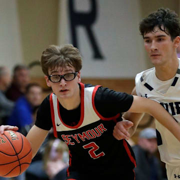 Seymour High School's Teage Cornell (2) gets past Xavier High School's Kyler Bleck (3) during their boys basketball game Tuesday, December 9, 2025, in Appleton, Wisconsin. Seymour won 82-69.