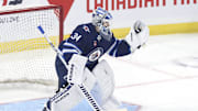 Sep 21, 2024; Winnipeg, Manitoba, CAN;  Winnipeg Jets goaltender Kaapo Kahkonen (34) warms up before a preseason game against the Minnesota Wild at Canada Life Centre. Mandatory Credit: James Carey Lauder-Imagn Images