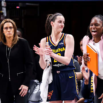 Aliyah Boston, Stephanie White, Caitlin Clark and Karima Christmas-Kelly (left to right) react during a Fever game.