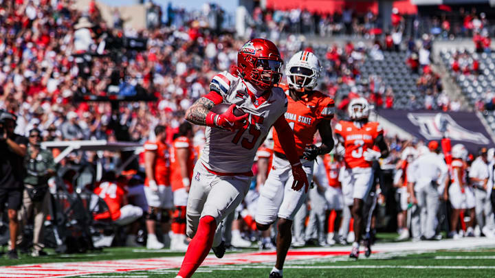 Oct 4, 2025; Tucson, Arizona, USA; Arizona Wildcats wide receiver Luke Wysong (15) scores a touchdown against the Oklahoma State Cowboys during the second quarter at Arizona Stadium. Mandatory Credit: Aryanna Frank-Imagn Images