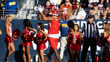 Nov 30, 2024; Tucson, Arizona, USA; Arizona Wildcats wide receiver Tetairoa McMillan (4) catches a touchdown against the Arizona State Sun Devils in the second half during the Territorial Cup at Arizona Stadium. Mandatory Credit: Mark J. Rebilas-Imagn Images