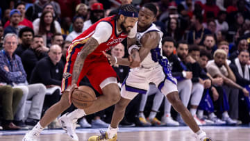 Apr 19, 2024; New Orleans, Louisiana, USA; Sacramento Kings guard De'Aaron Fox (5) attempts to steal the ball from New Orleans Pelicans forward Brandon Ingram (14) in the second half during a play-in game of the 2024 NBA playoffs at Smoothie King Center. Mandatory Credit: Stephen Lew-USA TODAY Sports