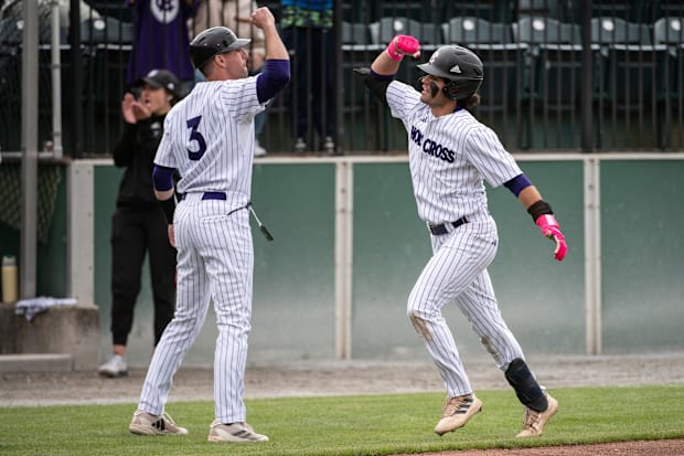 Holy Cross baseball coach Ed Kahovec, left, high fives Brendan Jones after he homered.