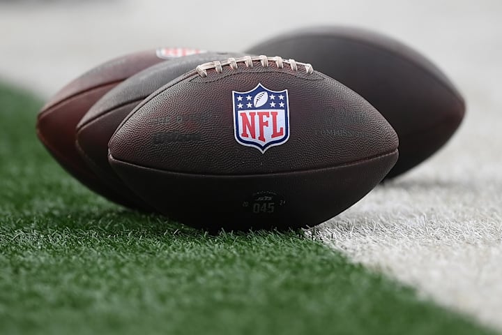 General view of the National Football League logo on footballs.