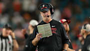 Oct 25, 2025; Miami Gardens, Florida, USA; Stanford Cardinal interim head coach Frank Reich reads a play card against the Miami Hurricanes during the third quarter at Hard Rock Stadium. Mandatory Credit: Sam Navarro-Imagn Images