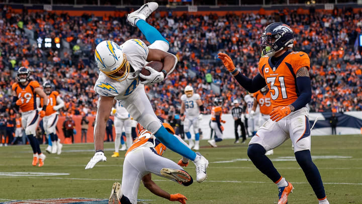 Jan 8, 2023; Denver, Colorado, USA; Los Angeles Chargers tight end Donald Parham Jr. (89) is upended by Denver Broncos cornerback Ja'Quan McMillian (35) as safety Justin Simmons (31) defends in the third quarter at Empower Field at Mile High. Mandatory Credit: Isaiah J. Downing-USA TODAY Sports