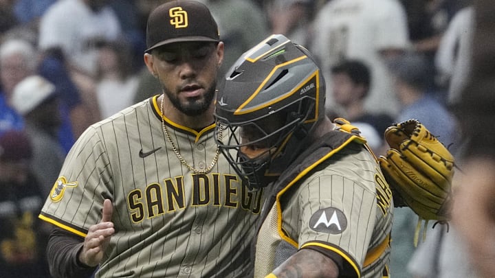 Jun 8, 2025; Milwaukee, Wisconsin, USA; San Diego Padres pitcher Robert Suarez (75) and San Diego Padres catcher Martín Maldonado (15) celebrate a 1-0 win over the Milwaukee Brewers at American Family Field. Mandatory Credit: Michael McLoone-Imagn Images