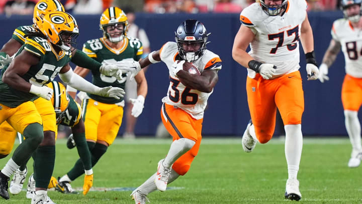 Denver Broncos running back Tyler Badie (36) gashes the Green Bay Packers defense for a big run.