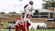 Nyziah Hunter leaps over Maryland Terrapins defensive back Jamare Glasker for a touchdown.