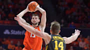 Feb 25, 2025; Champaign, Illinois, USA;  Illinois Fighting Illini center Tomislav Ivisic (13) looks to pass as Iowa Hawkeyes guard Carter Kingsbury (14) defends during the first half at State Farm Center. Mandatory Credit: Ron Johnson-Imagn Images