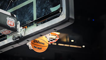 Mar 13, 2025; Kansas City, MO, USA; NCAA regulation basketball drops through the basket during the second half of the game between the Arizona Wildcats and the Kansas Jayhawks at T-Mobile Center. Mandatory Credit: William Purnell-Imagn Images