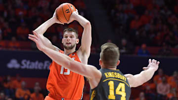 Feb 25, 2025; Champaign, Illinois, USA;  Illinois Fighting Illini center Tomislav Ivisic (13) looks to pass as Iowa Hawkeyes guard Carter Kingsbury (14) defends during the first half at State Farm Center. Mandatory Credit: Ron Johnson-Imagn Images