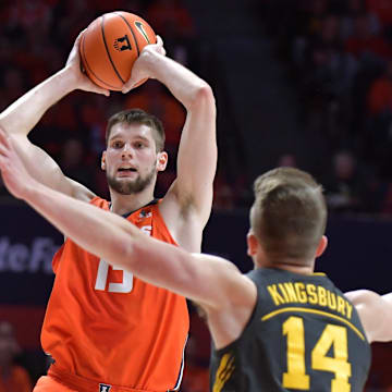 Feb 25, 2025; Champaign, Illinois, USA;  Illinois Fighting Illini center Tomislav Ivisic (13) looks to pass as Iowa Hawkeyes guard Carter Kingsbury (14) defends during the first half at State Farm Center. Mandatory Credit: Ron Johnson-Imagn Images