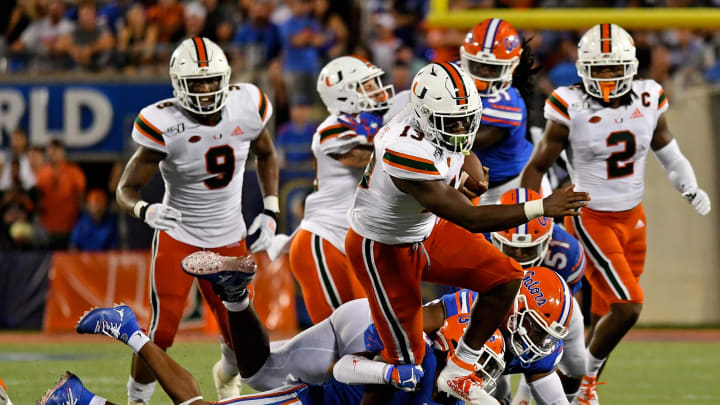 Aug 24, 2019; Orlando, FL, USA; Miami Hurricanes running back DeeJay Dallas (13) breaks a tackle against the Florida Gators during the second half at Camping World Stadium. Mandatory Credit: Jasen Vinlove-USA TODAY Sports