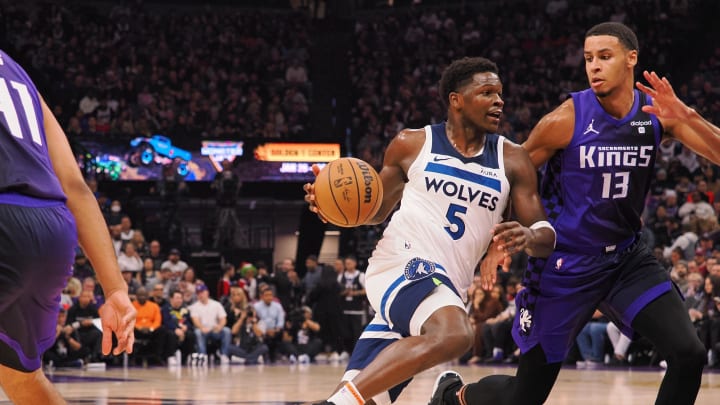 Dec 23, 2023; Sacramento, California, USA; Minnesota Timberwolves guard Anthony Edwards (5) drives in against Sacramento Kings forward Keegan Murray (13) during the first quarter at Golden 1 Center. Mandatory Credit: Kelley L Cox-USA TODAY Sports