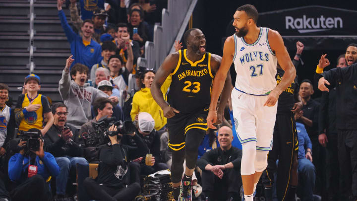 Nov 12, 2023; San Francisco, California, USA; Golden State Warriors forward Draymond Green (23) celebrates behind Minnesota Timberwolves center Rudy Gobert (27) after scoring a three point basket during the first quarter at Chase Center. Mandatory Credit: Kelley L Cox-USA TODAY Sports