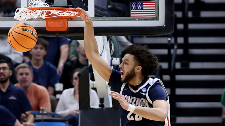 Mar 23, 2024; Salt Lake City, UT, USA; Gonzaga Bulldogs forward Anton Watson (22) dunks against Kansas Jayhawks forward K.J. Adams Jr. (24) during the second half in the second round of the 2024 NCAA Tournament at Vivint Smart Home Arena-Delta Center. Mandatory Credit: Rob Gray-USA TODAY Sports