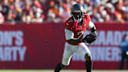 Nov 30, 2025; Tampa, Florida, USA; Tampa Bay Buccaneers running back Bucky Irving (7) runs during the second half against the Arizona Cardinals at Raymond James Stadium. 