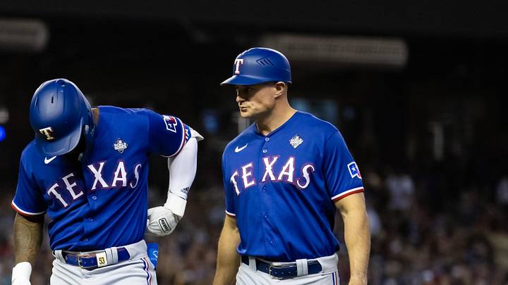 Oct 30, 2023; Phoenix, AZ, USA; Texas Rangers right fielder Adolis Garcia (left) reacts alongside first base coach Corey Ragsdale after after suffering an injury in the eighth inning of game three of the 2023 World Series against the Arizona Diamondbacks at Chase Field. 