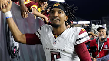 Sep 23, 2024; Cincinnati, Ohio, USA; Washington Commanders quarterback Jayden Daniels (5) celebrates with fans following the win against the Cincinnati Bengals at Paycor Stadium. Mandatory Credit: Joseph Maiorana-Imagn Images