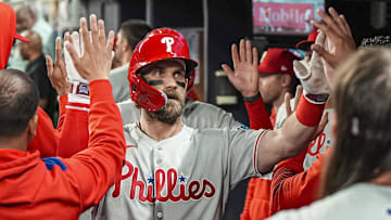 Apr 9, 2025; Cumberland, Georgia, USA; Philadelphia Phillies first base Bryce Harper (3) reacts in the dugout after hitting a two run home run against the Atlanta Braves during the seventh inning at Truist Park.