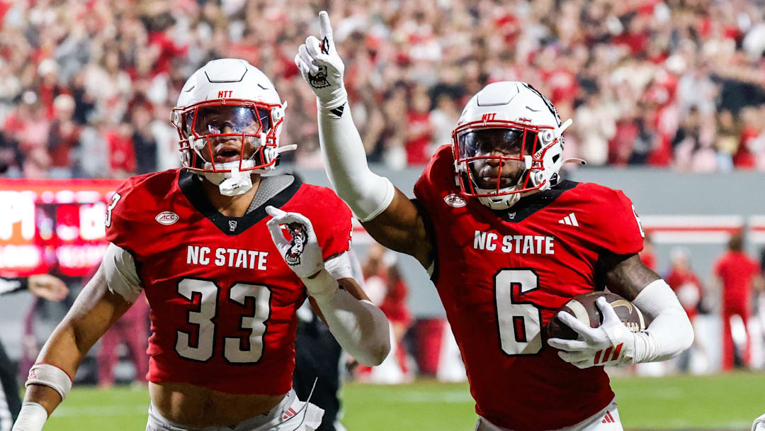 Nov 21, 2025; Raleigh, North Carolina, USA; NC State Wolfpack defensive back Devon Marshall (6) celebrates a down and runs towards the JROTC  to celebrate during the first half of the game against Florida State Seminoles at Carter-Finley Stadium. Mandatory Credit: Jaylynn Nash-Imagn Images