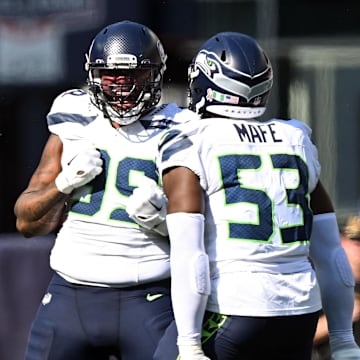 Sep 15, 2024; Foxborough, Massachusetts, USA;  Seattle Seahawks defensive end Leonard Williams (99) reacts with linebacker Boye Mafe (53) after a sack against New England Patriots quarterback Jacoby Brissett (7) during the second half at Gillette Stadium. Mandatory Credit: Brian Fluharty-Imagn Images