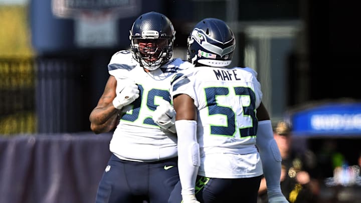 Sep 15, 2024; Foxborough, Massachusetts, USA;  Seattle Seahawks defensive end Leonard Williams (99) reacts with linebacker Boye Mafe (53) after a sack against New England Patriots quarterback Jacoby Brissett (7) during the second half at Gillette Stadium. Mandatory Credit: Brian Fluharty-Imagn Images