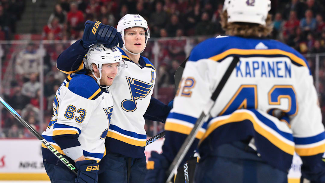 Star defenseman Colton Parayko celebrating with teammates Jake Neighbours and Kasperi Kapanen