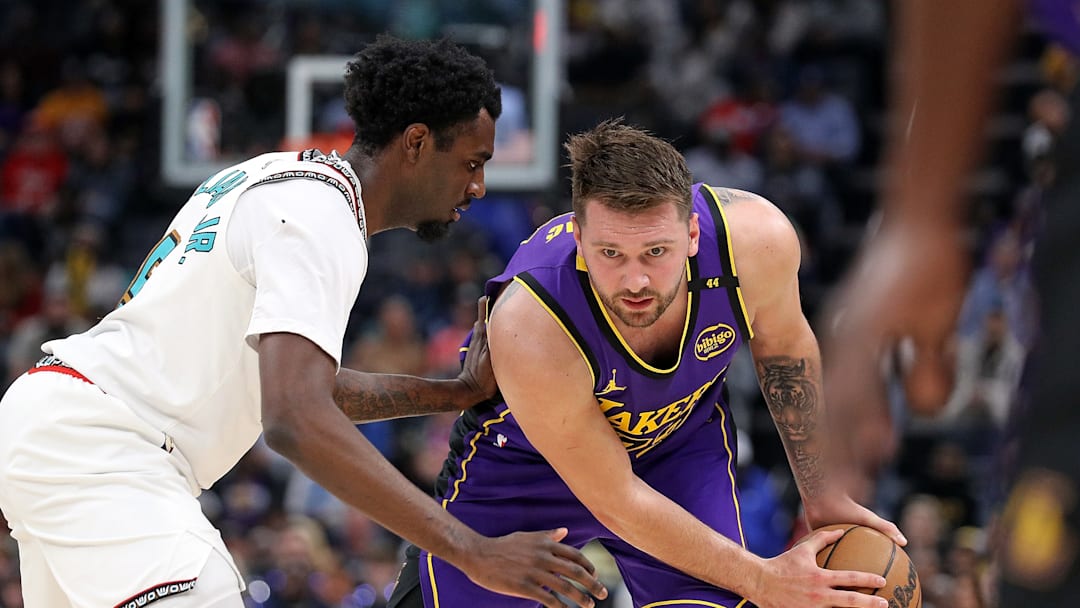 March 29, 2025; Memphis, Tennessee, USA; Luka Doncic (77) being guarded by Vince Williams Jr. (5) during the regular season. 