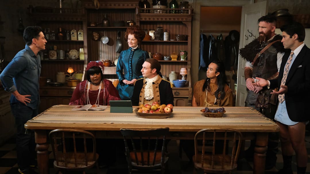 “Planes, Shanes and Automobiles” – Pictured (L-R): Ben Feldman as Kyle, Danielle Pinnock as Alberta, Rebecca Wisocky as Hetty, Brandon Scott Jones as Isaac, Román Zaragoza as Sasappis, Devan Chandler Long as Thorfinn, and Asher Grodman as Trevor. Photo: Bertrand Calmeau/CBS ©2025 CBS Broadcasting, Inc. All Rights Reserved.