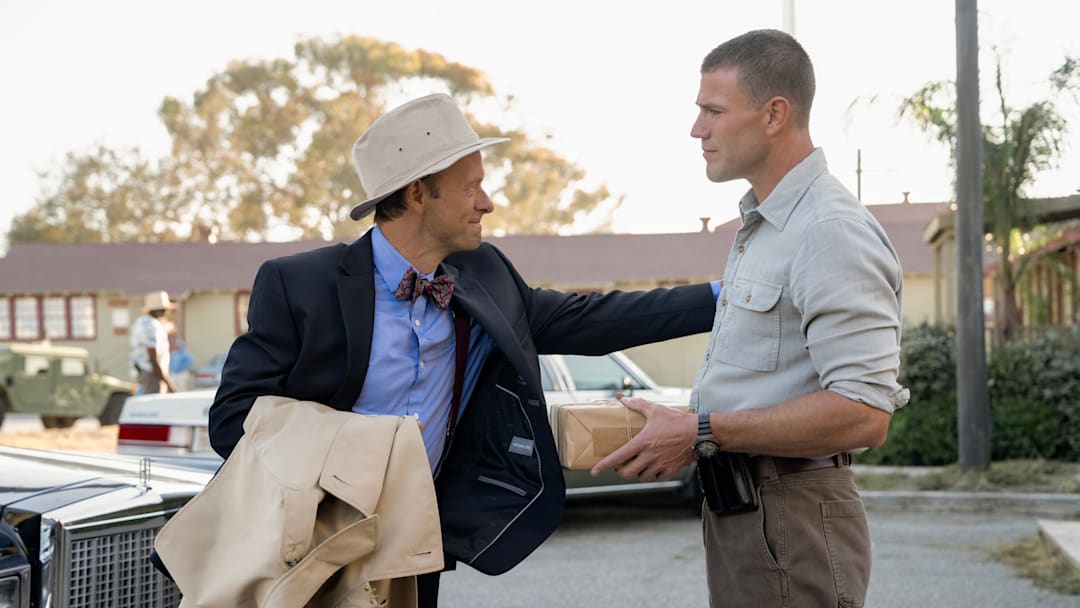 “The Edge” – NCIS: Origins season 2 - Pictured (L-R): Adam Campbell as Dr. Donald “Ducky” Mallard and Austin Stowell as Leroy Jethro Gibbs. Photo: Greg Gayne/CBS ©2025 CBS Broadcasting, Inc. All Rights Reserved.