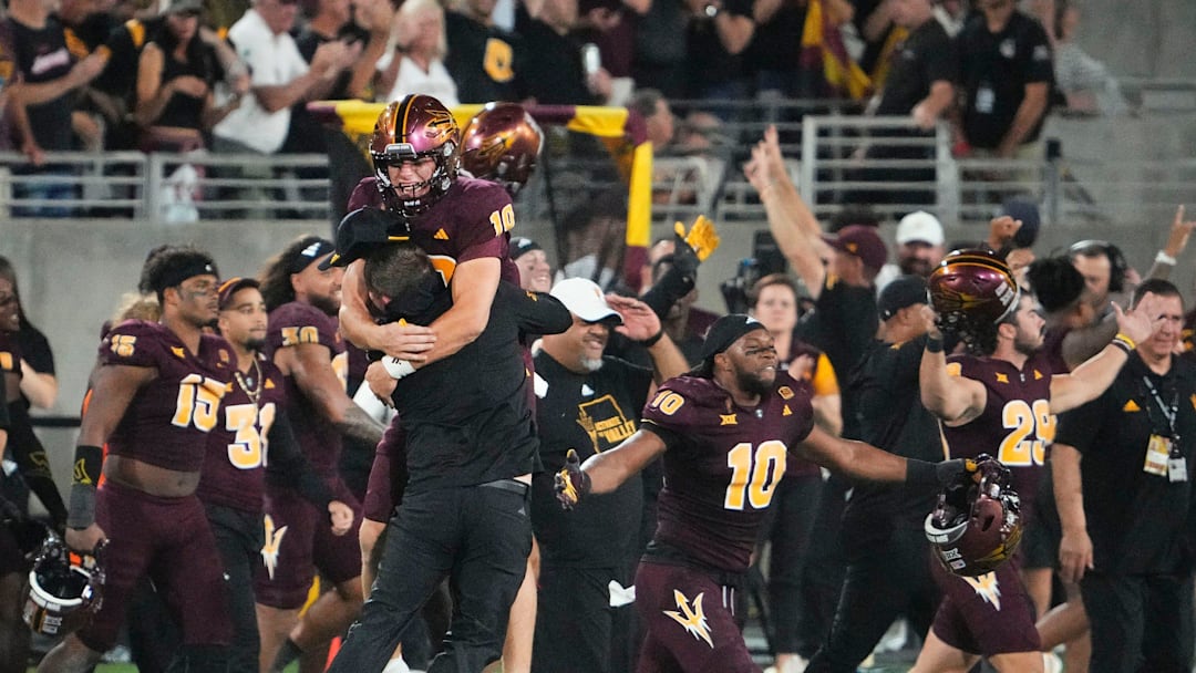 Oct 11, 2024; Tempe, Arizona, USA; Arizona State Sun Devils quarterback Sam Leavitt (10) jumps into the arms of head coach Kenny Dillingham after the the Sun Devils upset the (16) Utah Utes 27-19 at Mountain America Stadium. Mandatory Credit: Rob Schumacher-Arizona Republic